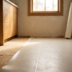 Sheet vinyl flooring unrolled across a prepared bathroom subfloor