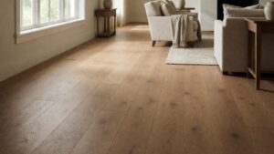 Wide oak planks running parallel to a bright window in a living room
